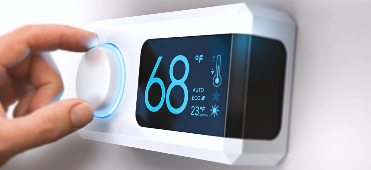 Smart thermostat displaying 68°F with a hand adjusting the temperature.