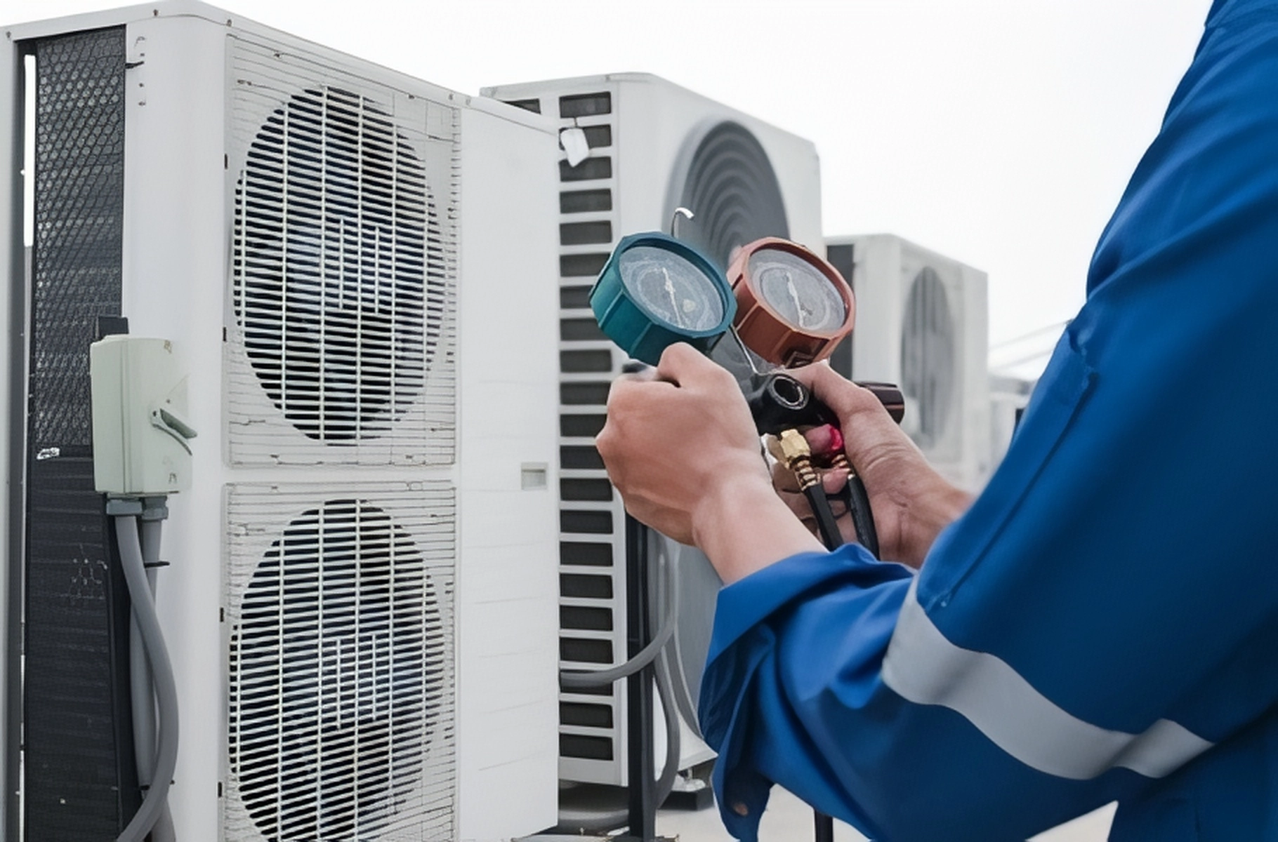 Technician using gauges on AC units for installation in Greenwich, CT.