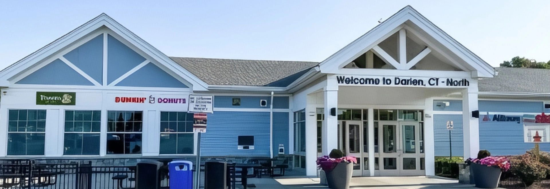 Welcome center building in Darien Center, CT with signage and storefronts.